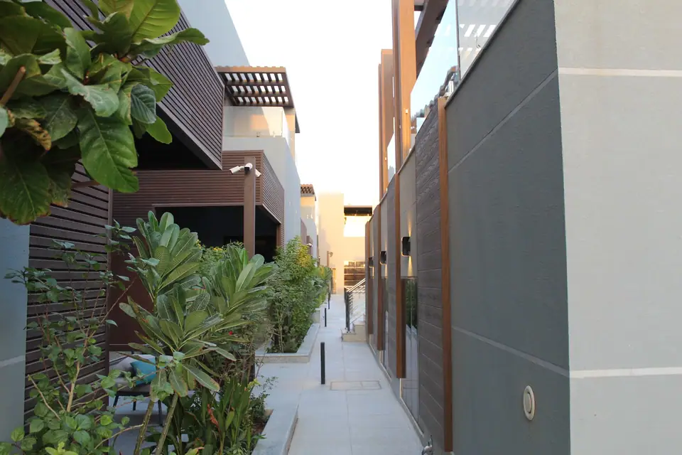 Planted walkway between the homes at Fay Compound