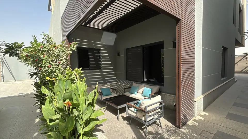 Private terrace with pergola and seating at a Fay Compound villa